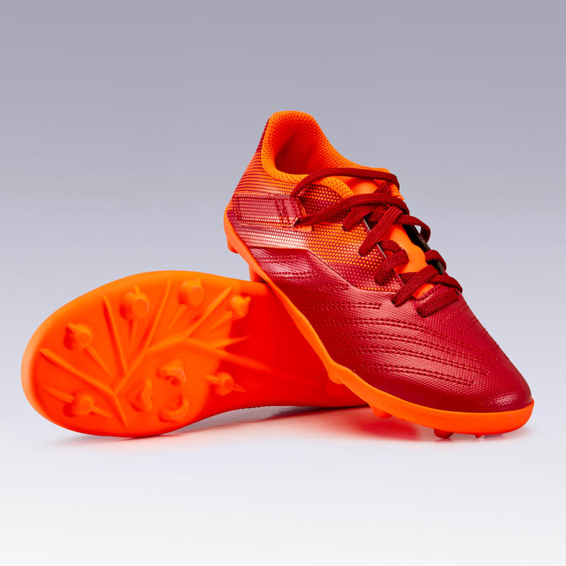 รองเท้าฟุตบอลเด็ก พร้อมแถบรัด สำหรับใส่เล่นบนพื้นสนามแน่นรุ่น Agility 140 FG (สีม่วงแดง/ส้ม)