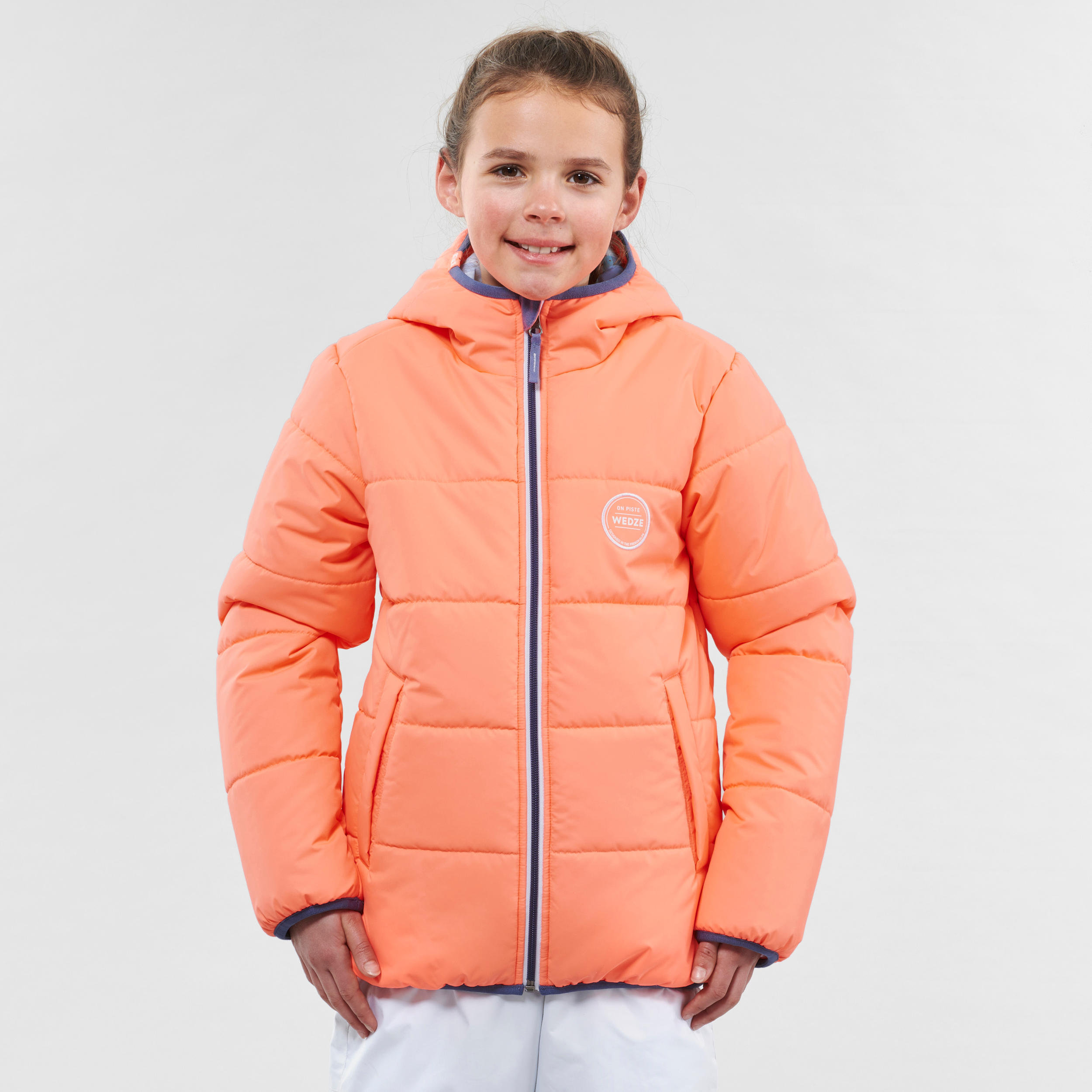 เสื้อแจ็คเก็ตแบบใส่ได้สองด้านสำหรับเด็กใส่เล่นสกีกันหนาวรุ่น 100 (สีส้ม CORAL/ฟ้า) สกี/สโนว์บอร์ด สกี เสื้อแจ็คเก็ต เสื้อผ้าเด็ก